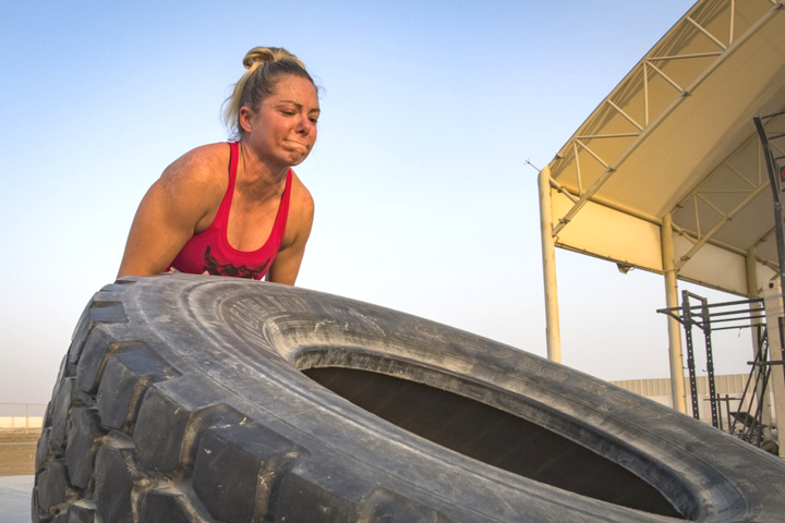 Master Sgt. Kimberly Kaminski, 380th Expeditionary Security Forces Squadron, flips a 445-pound tire during a workout at Al Dhafra Air Base, United Arab Emirates. Resistance training is just one of many steps to take to fight osteoporosis. (U.S. Air Force photo by Staff Sgt. Ross A. Whitley)