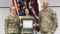 Lt. Col. Kim MacNeilly (C), Deputy Commander for Quality and Safety at Womack, has been awarded the DHA Patient Champion Certificate for her work at the facility. Womack Commander, Col. Stephanie Mont (L) and Sgt. Maj. Timothy Mollett presented the award.