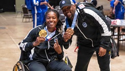 Army 1st Lt. Jani Merritt, left, and Army Capt. Tony Smith pose with their medals after wining the powerlifting competition at the 2026 Warrior Games