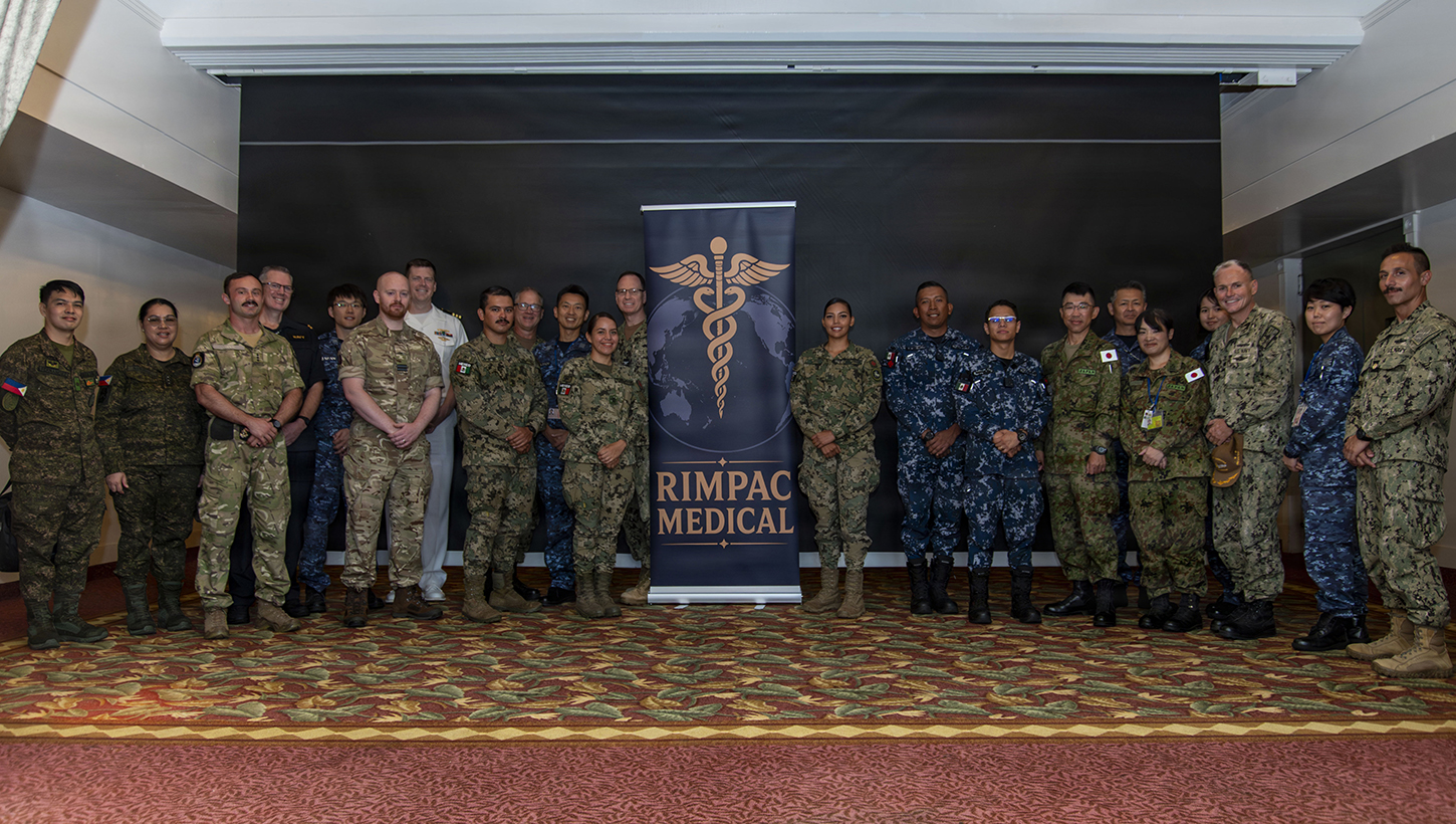 Service members pose for a picture at the RIMPAC Symposium