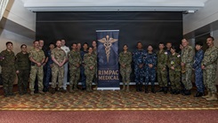 Service members pose for a picture at the RIMPAC Symposium