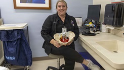 Dr. Kirby Smith, a pelvic health physical therapist in the Urogynecology Division, explains the different parts of the pelvic floor while holding an anatomical model 