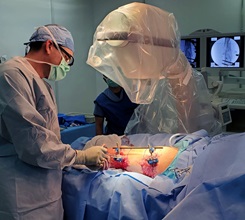U.S. Navy Cmdr. Scott Trask, a general surgeon, performs an external fixation of a femur at the Expeditionary Medical Facility