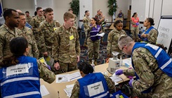Simulated patients process through the prophylaxis Point of Dispensing (POD) during a public health emergency exercise on Scott Air Force Base