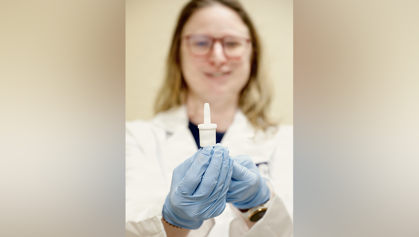 A researcher with Naval Medical Research Command's (NMRC) Clinical Trials Center (CTC) hold a self-administered nasal spray called INNA-051