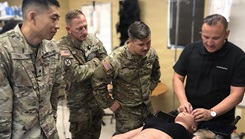 Medical trainers from Evans Army Community Hospital’s Department of Education observe, as a representative from "Operative Experience, Inc." provides a demonstration on one of the department's new high-fidelity mannequins