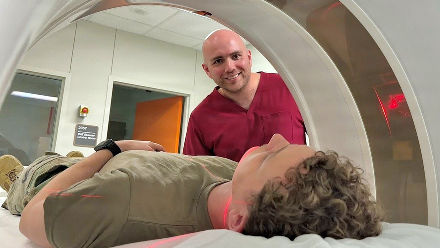 Spc. Johnny Rainwater, a radiology specialist at Bayne-Jones Army Community Hospital, conducts a staged computed tomography scan with a fellow Soldier