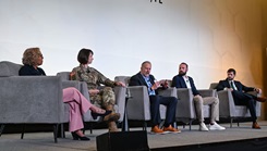 Retired Army Maj. Gen. Clayton M. Hutmacher, center, speaks on the optimizing human performance panel