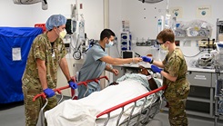 Students from the U.S. Army John F. Kennedy Special Warfare Center and School who are in the Special Operations Combat Medic Course work alongside a trauma specialist
