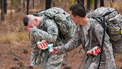 Military personnel walking in the woods