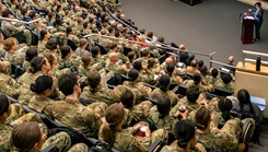Deputy Assistant Secretary of Defense for Health Services Policy and Oversight Susan Orsega addresses a full auditorium of students, faculty, and staff at the Uniformed Services University 