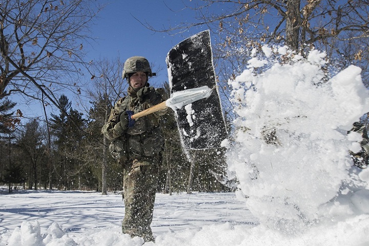 Army Sgt. 1st Class Joseph Seifridsberger shovels knee-deep snow to build a simulated hasty firing position during training exercise Ready Force Breach at Fort Drum, New York. (U.S. Army photo by Sgt. Andrew Carroll)
