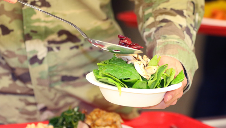 A soldier is eating healthy foods.