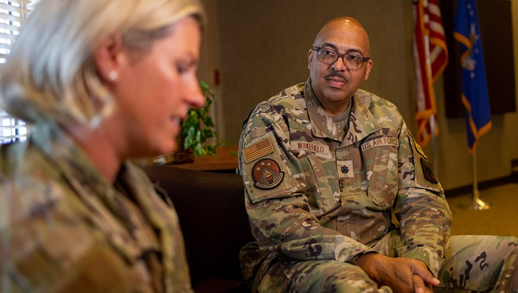 Image of military personnel engaged in conversation.