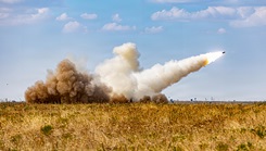 Soldiers assigned to the 2nd Battalion, 4th Field Artillery Regiment, 75th Field Artillery Brigade, fire a rocket from an M270 Multiple Launch Rocket System