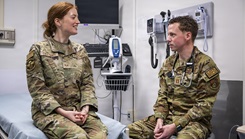 U.S. Air Force Capt. Zachary Hicks, 374th Health Care Operations Squadron family medicine physician, simulates a patient screening with Senior Airman Sofia Colesanti, 374th Health Care Operations during a patient visit 