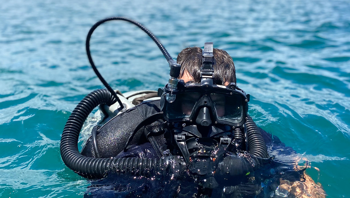 Navy Diver 3rd (ND3) Class Travis Jones in water wearing diving gear