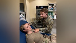 Senior Airman Travis J. Gawronski, then-332nd Expeditionary Medical Squadron aerospace medical technician, stages a checkup with an Airman