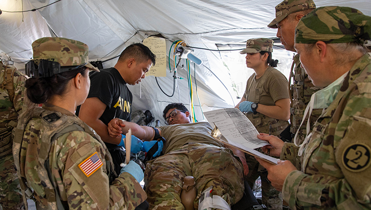 U.S. Army Reserve soldiers with the 352nd Field Hospital assess a simulated casualt