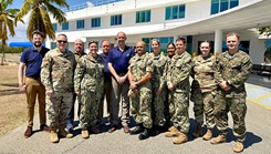 Front row, from left, Brig. Gen. John Andrus, Joint Staff Surgeon; U.S. Navy Capt. Tammy Servies, director of U.S. Naval Hospital Guantanamo Bay, commanding officer of U.S. Navy Medicine Readiness and Training Command Guantanamo Bay, commander of Joint Medical Group, Joint Task Force Guantanamo Bay; and Dr. Steven Ferrara, Acting Assistant Secretary of Defense for Health Affairs, pose for a photo with members of his delegation and personnel from U.S. Naval Hospital Guantanamo Bay outside the hospital