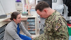Ensign Megan McLaughlin performing musculoskeletal examination