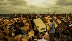 U.S. Air Force Maj. Tom Cooke helps residents search through the rubble of a leveled home, after a tornado ripped through parts of Moore, Okla., May 20, which damaged more than 13,000 homes. (U.S. Air Force photo by Staff Sgt. Jonathan Snyder)