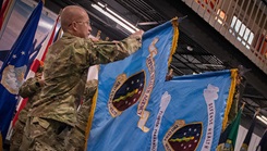 Leadership unfurls the DHA guidons during a ceremony 