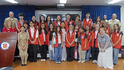 Capt. Joshua Miller, commanding officer of U.S. Navy Medicine Readiness and Training Command (USNMRTC) Yokosuka and director of U.S. Naval Hospital (USNH) Yokosuka, and American Red Cross staff pose for a group photo with the summer VolunTEEN participants