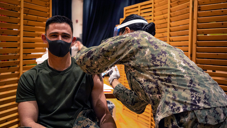 Image of Soldier getting a vaccine in his left arm. Click to open a larger version of the image.