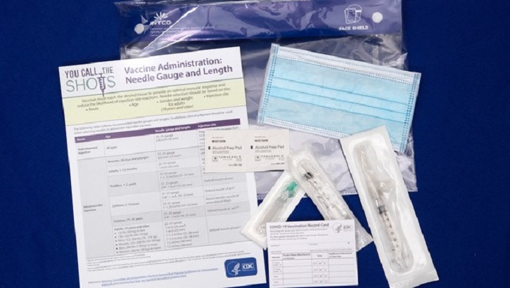 Image of Image with documents and vaccine products laying on table. Click to open a larger version of the image.
