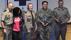 U.S. Army Col. Kenneth Dwyer (left), commander of the Leader Training Brigade at Fort Jackson, South Carolina, thanks and recognizes members of Walter Reed's nursing team