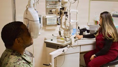 Catherine Ortiz (right), a Doctor of Optometry student form Western University of Health Sciences, conducts an eye examination with Hospital Corpsman 2nd Class Emilio Matthew