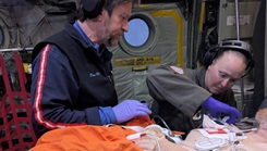 Dan Baldwin (left), University of Texas flight nurse, Master Sgt. Lyndsey Glotfelty, 187th Wyoming Air National Guard aeromedical evacuation technician, provide in-flight care for a heart attack victim aboard a LC-130