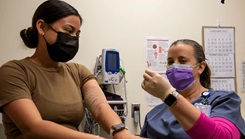 Military medical personnel at medical examination