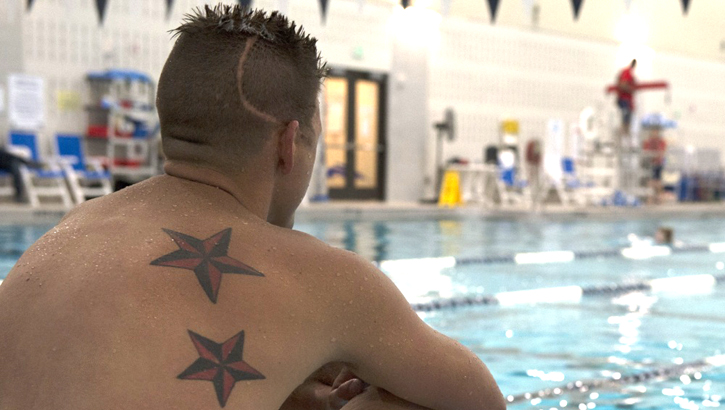 A sailor in the Navy's Wounded Warrior program at Naval Support Activity in Bethesda, Maryland, sits poolside after training. Recovery care coordinators who work within warrior care programs coordinate non-medical care for wounded, ill, and injured service members and provide resources and support to family members. (Photo by Petty Officer 2nd Class Christopher Hurd) 