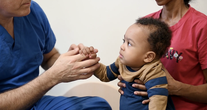 Medical military personnel checking out a baby