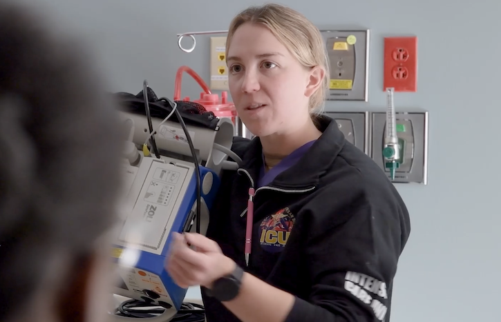 A nurse explaining how to use a machine