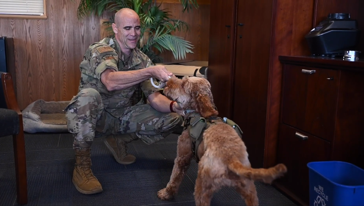 Link to Video: U.S. Air Force Col. Adam Roberts, the 555th Rapid Engineer Deployable Heavy Operational Repair Squadron Engineers (RED HORSE) commander, practices resiliency each day alongside his best friend and service dog, Porsche, a loveable labradoodle with golden brown fur resembling the look and feel of a stuffed animal.