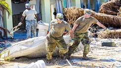 Military personnel helping clean up during a natural disaster