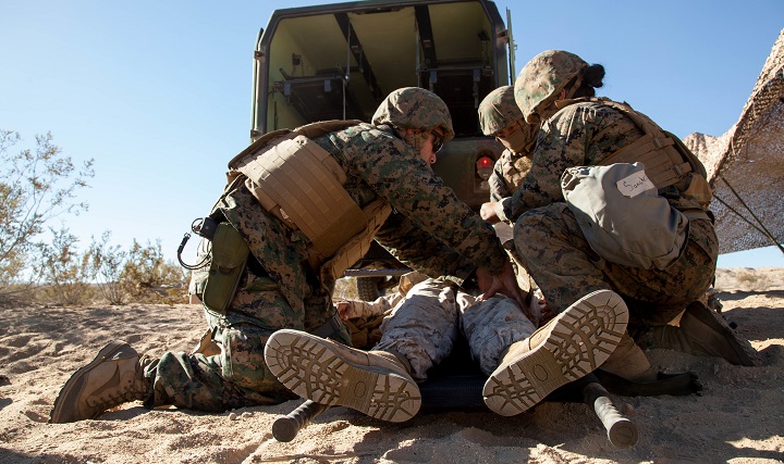 Hospital corpsmen and Marines check a simulated casualty and remove their body armor during Exercise Steel Nightâs mass casualty drill at Marine Corps Air Ground Combat Center Twentynine Palms, Calif., Dec. 12, 2015. The drill tested the 1st Marine Divisionâs ability to react to a large influx of injuries and wounds from battling the enemy. Steel Knight provides tough, realistic training for the Marines and sailors of 1st Marine Division.