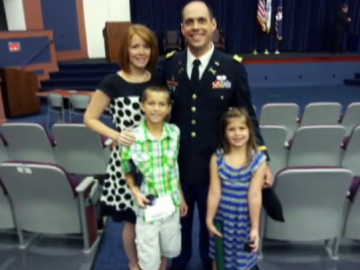 Image of a service member and his family