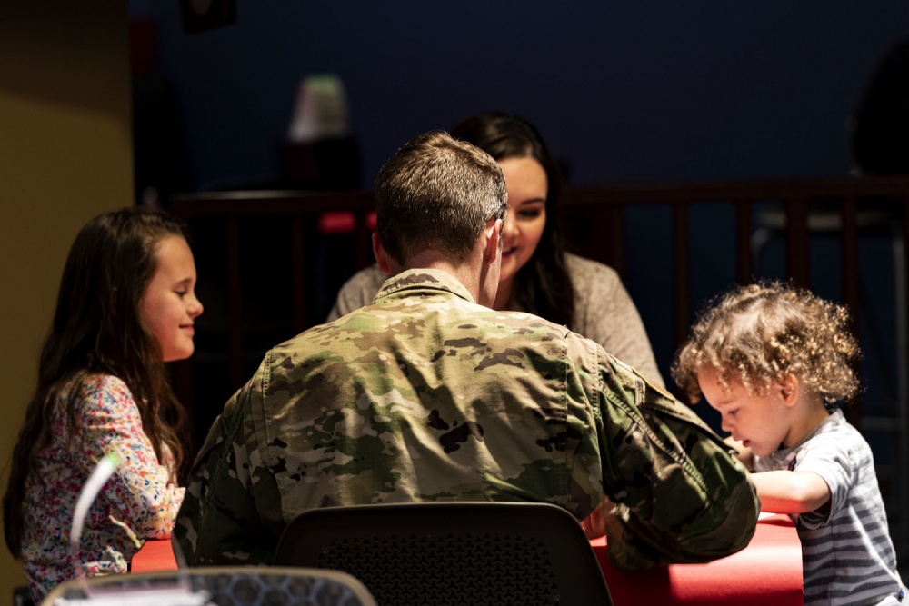 military family sitting at a table together